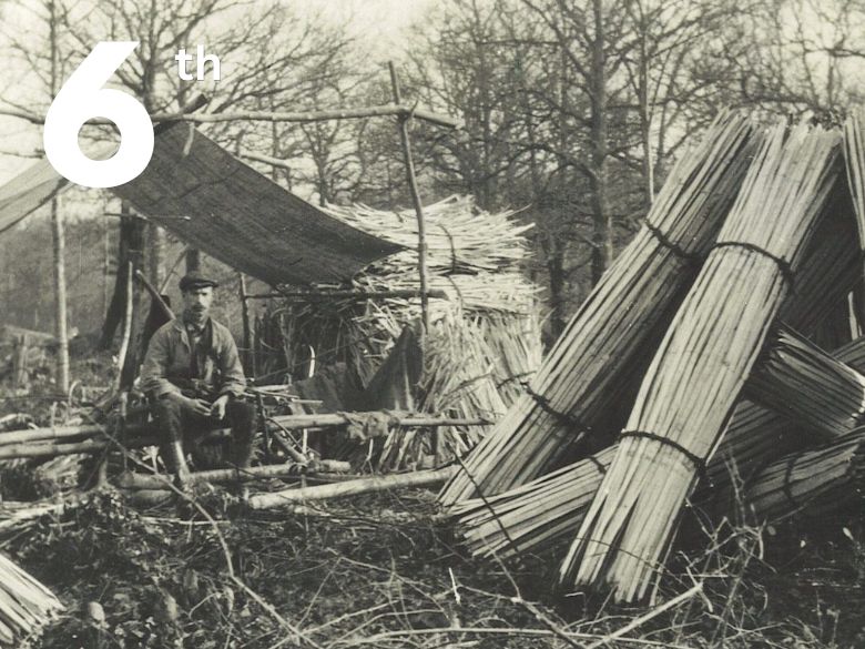 Old photo of a woodsman with his work