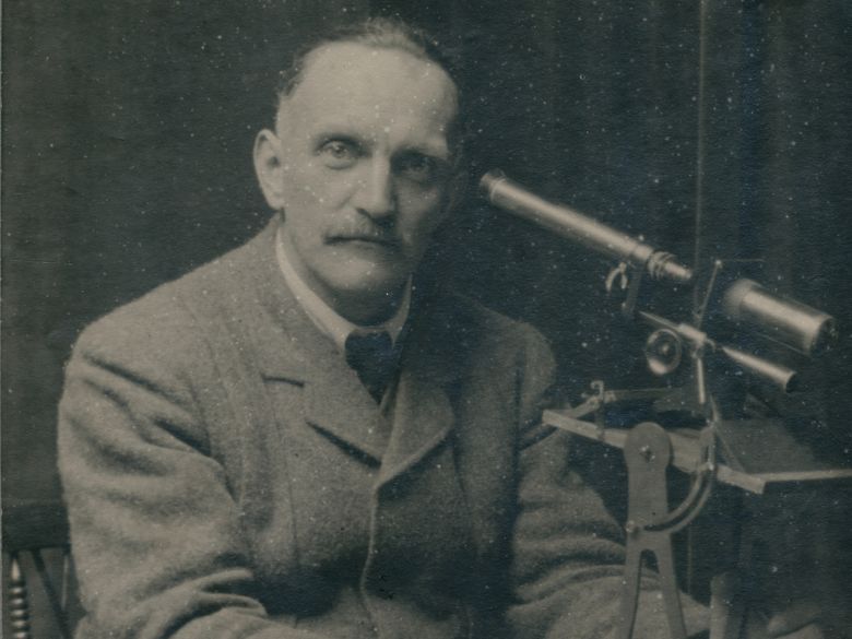 Museum curator with microscope